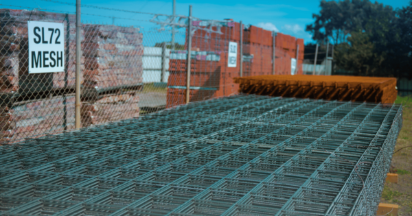 SL72 reinforcing mesh stacked at a construction site, ready for use in concrete reinforcement.