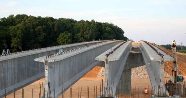 Bridge construction in progress – Featuring precast concrete girders and reinforced rebar for enhanced structural integrity.