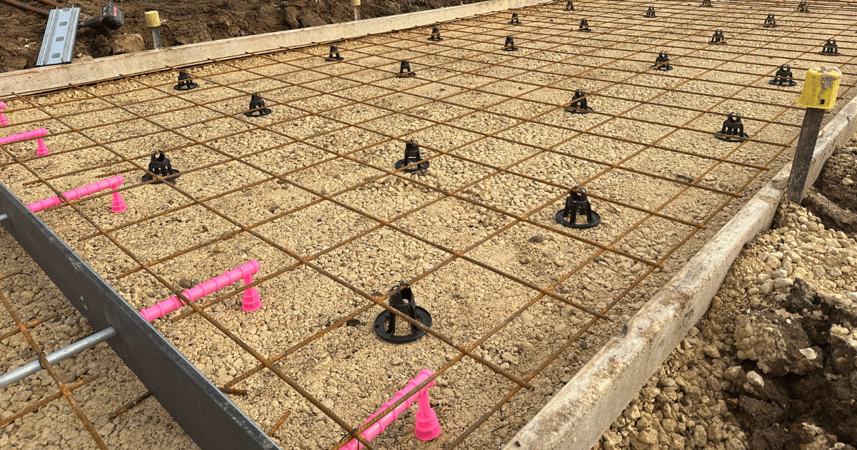 Concrete slab on ground with rebar supported by combination SOG bar chairs for precision reinforcement placement.