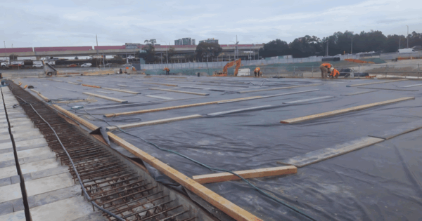 Concrete slab covered with wet curing blankets on an Australian construction site