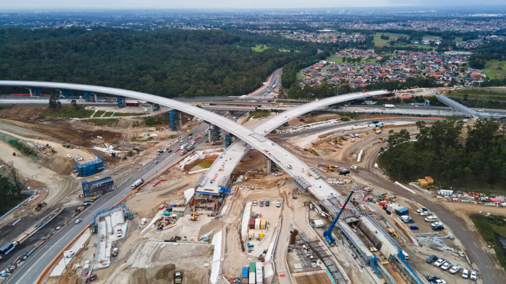 M7–M12 Interchange project under construction in Western Sydney, showing new bridge ramps, roadworks, and motorway upgrades.