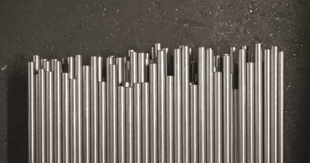 Stainless steel dowel bars aligned for installation in concrete pavement joints.