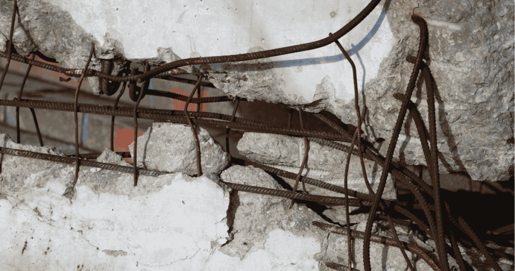 Exposed rusted reinforcing steel showing severe concrete cancer and concrete spalling