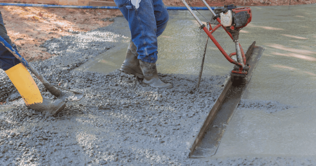 Workers finishing fresh concrete before applying a concrete curing compound to support proper curing and surface performance.